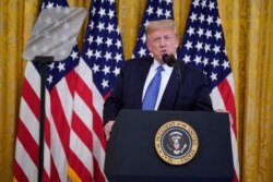 FILE - President Donald Trump speaks during an event on "Operation Legend: Combating Violent Crime in American Cities," in the East Room of the White House, July 22, 2020.