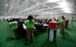 Staff oversee breakfast at the U.S. government's newest holding center for migrant children in Carrizo Springs, Texas, July 9, 2019.