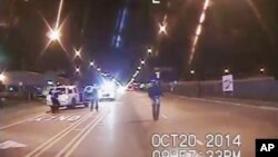A frame grab from dash-cam video provided by the Chicago Police Department shows Laquan McDonald (R) walks down the street moments before being shot by officer Jason Van Dyke on Oct. 20, 2015.