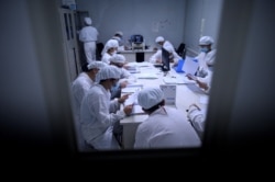 Researchers work in a lab at the Yisheng Biopharma company in Shenyang, in China’s northeast Liaoning province on June 10, 2020. - The company is one of a number in China trying to develop a vaccine for the COVID-19.