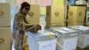 A woman casts her vote in elections in Mbare, Harare, Zimbabwe, early Wednesday July 31, 2013. Zimbabweans voted Wednesday in the elections that will determine the future of longtime President Robert Mugabe, who has denied allegations of vote-rigging desp