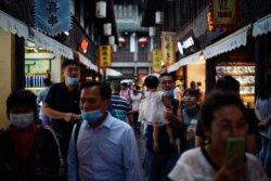 People wearing face masks walk on Jinli Ancient Street, following the coronavirus disease (COVID-19) outbreak, in Chengdu, Sichuan province, China, Sept. 8, 2020.