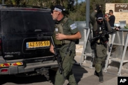 Israeli security forces secure a road near where Israel's government says a drone launched toward Israeli Prime Minister Benjamin Netanyahu's house in Caesarea, Israel, Oct. 19, 2024.