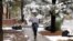 FILE - A student at Northern Arizona University walks through the campus in Flagstaff, Nov. 4, 2015, during the city's first snowfall of the season.