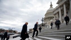 President Donald Trump, foreground, arrives on Capitol Hill for a Senate Republican policy lunch, in Washington, Jan. 9, 2019.