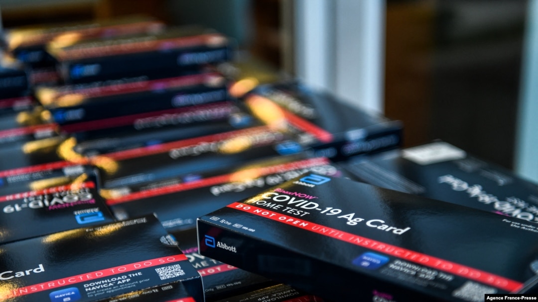 Employees of the Miami-Dade Public Library System distribute COVID-19 home rapid test kits in Miami, Florida, on Jan. 8, 2022