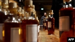 FILE - Visitors attend a tour of Hennessy's cellars in Cognac, France, Feb. 9, 2018. China said on Oct. 8, 2024, it would impose anti-dumping measures on brandy imported from the EU, amid an escalating trade row between Beijing and Brussels.