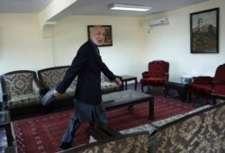 Former Afghan President Hamid Karzai leaves after an interview with the Associated Press at his house, in Kabul, Afghanistan, June 20, 2021.