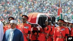 Kenyan military pallbearers carry the casket of former president Daniel arap Moi, draped in a Kenyan flag, at his state funeral in Nyayo Stadium, in Kenya's capital of Nairobi, Kenya, Feb. 11, 2020. 