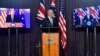 Australia's Prime Minister Scott Morrison, center, appears on stage with video links to Britain's Prime Minister Boris Johnson, left, and U.S. President Joe Biden at a joint press conference at Parliament House in Canberra, Sept. 16, 2021.