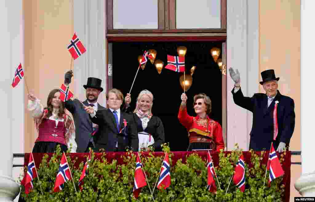Norway's Queen Sonja and King Harald, Crown Prince Haakon, Crown Princess Mette-Mari, Princess Ingrid Alexandra and Prince Sverre Magnu waves Norwegian flags, during the Norwegian Constitution Day, in Oslo.