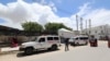 An ambulance is seen near a blast site that rocked a military base in Mogadishu, Somalia August 8, 2020. 