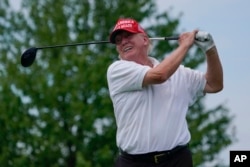 FILE - Former President Donald Trump plays during the pro-am round of the Bedminster Invitational LIV Golf tournament in Bedminster, NJ., on July 28, 2022.