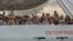 Migrants arrive on the British vessel HMS Enterprise before disembarking in the Sicilian harbour of Catania, Italy, Oct. 6, 2015.