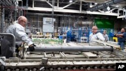 Workers at the Blue Grass Chemical Agent Destruction Pilot Plant in the United States begin the destruction of a stockpile of M55 rockets with GB nerve agent.