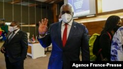 FILE - Botswana President Mokgweetsi Masisi, center, waves as he leaves a meeting in Pretoria, South Africa, Oct. 5, 2021.