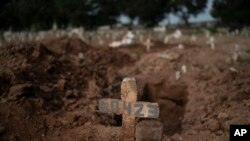 A cross marks the grave of 57-year-old Paulo Jose da Silva, who died from COVID-19, in Rio de Janeiro, Brazil, June 5, 2020.