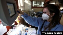 FILE - A health care worker talks to a man recovered from the coronavirus disease as he donates convalescent plasma at the Hemotherapy Institute in La Plata, Argentina, Oct. 5, 2020. (Reuters)