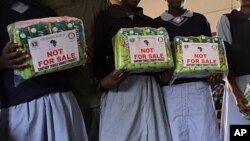 Girls receive a year's worth of sanitary napkins from Freedom for Girls, Mathare slums in Nairobi, Kenya, Feb. 9, 2012. (Jill Craig/VOA)