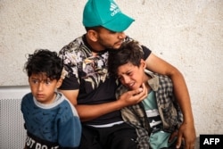 A child mourns the death of people killed in overnight Israeli bombardment, in the front of the morgue of a hospital in Rafah in the southern Gaza Strip on April 27, 2024, as the conflict between Israel and the militant group Hamas continues.