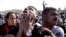 An anti-Hosni Mubarak protester reacts after hearing the verdict of the trial of the former Egyptian President outside a police academy on the outskirts of Cairo Saturday, Nov. 29, 2014.