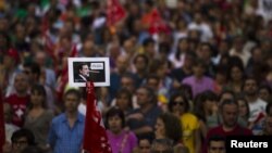 Seorang pengunjuk rasa membawa photo PM Spanyol Mariano Rajoy, yang menggambarkannya sebagai tokoh cerita kartun Pinokio saat mengatakan "Saya tidak berbohong" dalam aksi protes menentang langkah penghematan di Madrid (20/6).