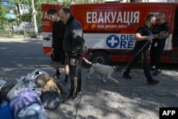 A unpaid  evacuates a canine  whose owners evacuated from the metropolis  of Pokrovsk successful  the Donetsk region, Sept. 21, 2024. For months, Moscow has been trying to seizure  Pokrovsk, a now-deserted metropolis  that was erstwhile  location  to 60,000.