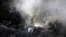 FILE - Volunteers look for survivors of a plane that crashed in a residential area of Karachi, Pakistan, May 22, 2020. 