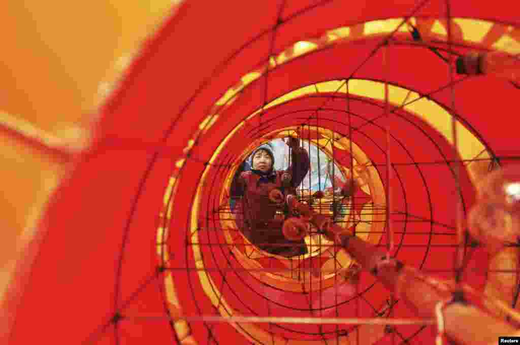 An employee works on a dragon lantern at a traditional lantern factory for the upcoming Chinese Lunar New Year, in Zibo, Shandong province. The Lunar New Year, or the Spring Festival, begins on February 10 and marks the start of the Year of the Snake.