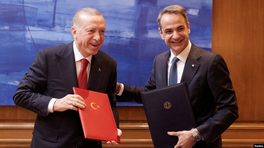 Greek Prime Minister Kyriakos Mitsotakis, right, and Turkish President Recep Tayyip Erdogan smile after signing a joint declaration to pursue good relations, at the Maximos Mansion in Athens, Greece, on Dec. 7, 2023. (Greek Prime Minister’s Office via Reuters)