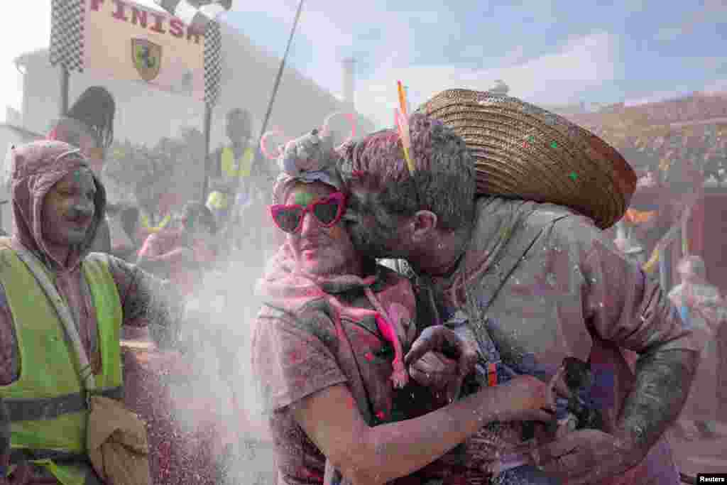 Revelers participate in &#39;flour war,&#39; dousing each other with tons of colored flour, marking Clean Monday-the end of carnival season in the coastal town of Galaxidi, Greece.