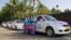 Female drivers from the 'She Taxi' service pose next to a taxi on a road in the southern Indian city of Kochi, Dec.12, 2014.