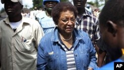 An election official checks the voter registration card for incumbent leader Ellen Johnson-Sirleaf during presidential elections at her home village of Fefee outside the capital Monrovia November 8, 2011.