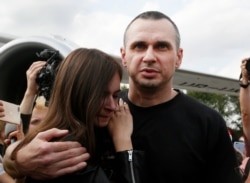 Ukrainian filmmaker Oleg Sentsov hugs his daughter upon his arrival at Boryspil airport, outside Kyiv, Sept. 7, 2019.