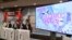 Japan Anime Tourism Association officials attend a press conference on the newly formed association in Tokyo, Sept. 16, 2016, while showing an image of a Japanese TV animation series on the screen.