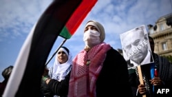 FILE—A protester holds a placard depicting the portrait of Israel's Prime Minister Benjamin Netanyahu and bearing the inscription "Fascist" during a rally called by several French organisations in support of Palestinian people at Place de la Republique in Paris on May 7, 2024.