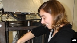 Lamont Research Director Heather Savage prepares a machine in the Rock Mechanics Laboratory that will simulate earthquake conditions on a micro-scale.