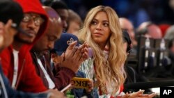 FILE - Beyonce sits at court side during the second half of the NBA All-Star basketball game in New Orleans.
