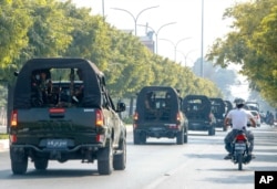 FILE - An army convoy patrols the streets in Mandalay, Myanmar, Feb. 3, 2021. In the early hours of Feb. 1, 2021, the Myanmar army took over the civilian government of Aung San Suu Kyi in a coup over allegations of fraud in November's elections.