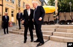 European Commission President Jean-Claude Juncker, left, shakes hands with British Prime Minister Boris Johnson prior to a meeting at a restaurant in Luxembourg, Monday, Sept. 16, 2019. British Prime Minister Boris Johnson was holding his first…