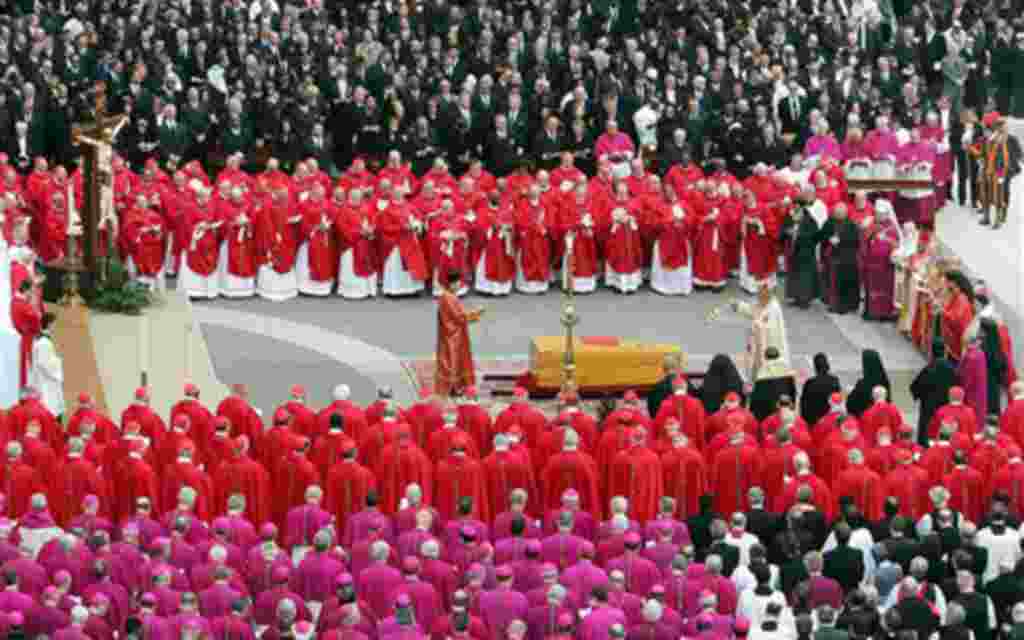 Cardinals, in red, bishops and dignitaries attend Pope's John Paul II funeral in St. Peter's Square at the Vatican, Friday April 8, 2005. Tens of thousands of people jammed St. Peter's Square to say a final farewell to Pope John Paul II in the presence of