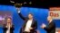 Social Democratic Party, SPD, chairman Martin Schulz, right, and outgoing Secretary General Hubertus Heil, left, applaud to newly elected General Secretary Lars Klingbeil on the second day of the party's convention in Berlin, Friday, Dec. 8, 2017.