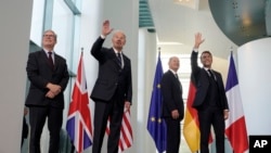 Prime Minister Keir Starmer of the United Kingdom, U.S. President Joe Biden, Chancellor Olaf Scholz of Germany, and President Emmanuel Macron of France, from left, gather at the Chancellery in Berlin, Germany, Oct. 18, 2024.