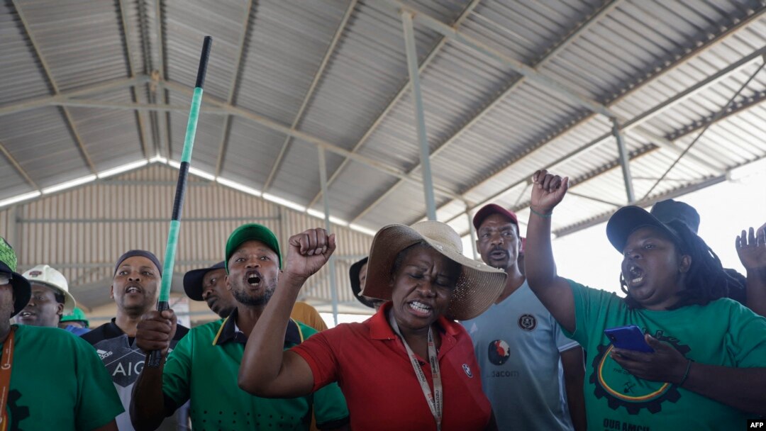 FILE - Mineworkers demonstrate at the entrance of the Gold One Modder East operation mineshaft in Springs on October 25, 2023.