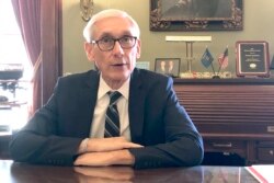 FILE - In this Dec. 19, 2019, file photo, Wisconsin Gov. Tony Evers sits for an interview with The Associated Press at his office in Madison, Wisc.