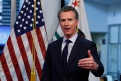 FILE - California Gov. Gavin Newsom gestures during a news conference in Rancho Cordova, Calif., April 14, 2020.