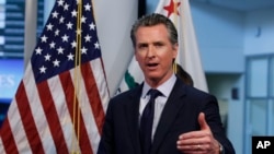 FILE - In this April 14, 2020, photo, California Gov. Gavin Newsom gestures during a news conference at the Governor's Office of Emergency Services in Rancho Cordova, Calif. 