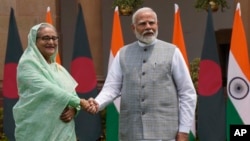 Bangladeshi Prime Minister Sheikh Hasina shakes hands with Indian Prime Minister Narendra Modi before their meeting in New Delhi on June 22, 2024. Hasina is on a two-day state visit to India.