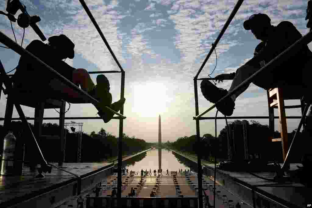 The early morning sun rises over the Washington Monument and the Reflecting Pool as final preparations are made for the March on Washington, Aug. 28, 2020, at the Lincoln Memorial in Washington.