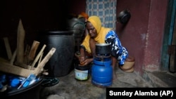 Idowu Bello, 56, prepares a meal in her kitchen in Ibadan, Nigeria, Friday, Sept. 13, 2024.